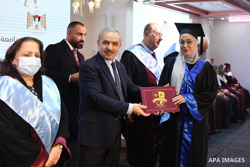 Palestinian Prime Minister Mohammed Ishtayeh participates in the graduation ceremony of the first cohort of Nablus University for Vocational and Technical Education, in the West Bank city of Ramallah, on November 21, 202...