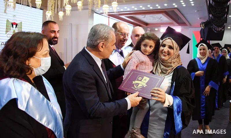 Palestinian Prime Minister Mohammed Ishtayeh participates in the graduation ceremony of the first cohort of Nablus University for Vocational and Technical Education, in the West Bank city of Ramallah, on November 21, 202...