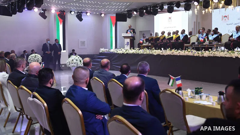 Palestinian Prime Minister Mohammed Ishtayeh participates in the graduation ceremony of the first cohort of Nablus University for Vocational and Technical Education, in the West Bank city of Ramallah, on November 21, 202...
