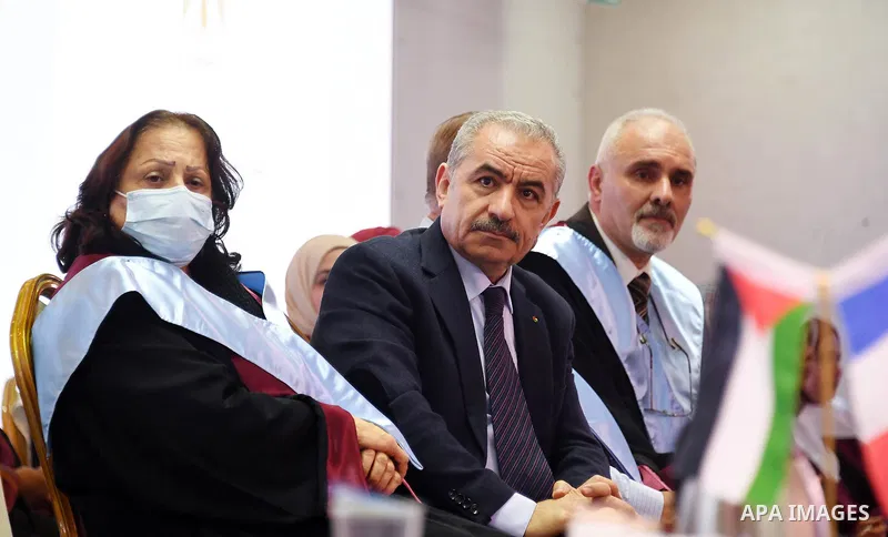 Palestinian Prime Minister Mohammed Ishtayeh participates in the graduation ceremony of the first cohort of Nablus University for Vocational and Technical Education, in the West Bank city of Ramallah, on November 21, 202...