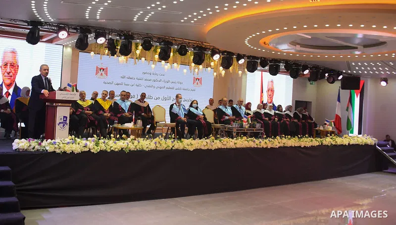 Palestinian Prime Minister Mohammed Ishtayeh participates in the graduation ceremony of the first cohort of Nablus University for Vocational and Technical Education, in the West Bank city of Ramallah, on November 21, 202...