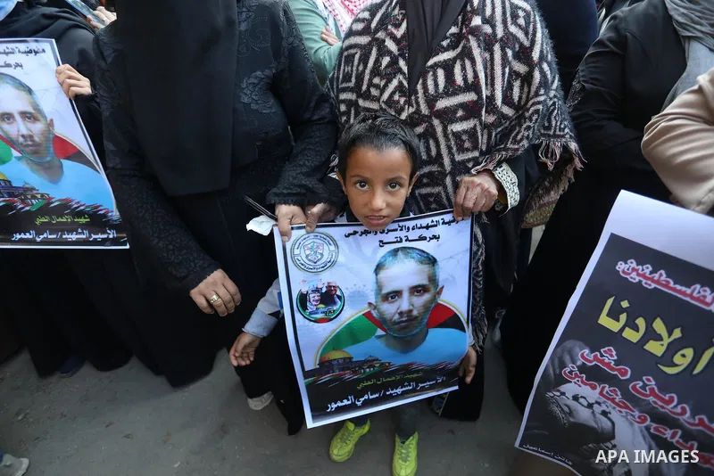 Palestinians take part in a protest against the death of prisoner Sami al-Amour in Israeli Jails as a result of intentional medical negligence, in Red cross office, in Gaza city on November 22, 2021. The al-Amour, 39, fr...