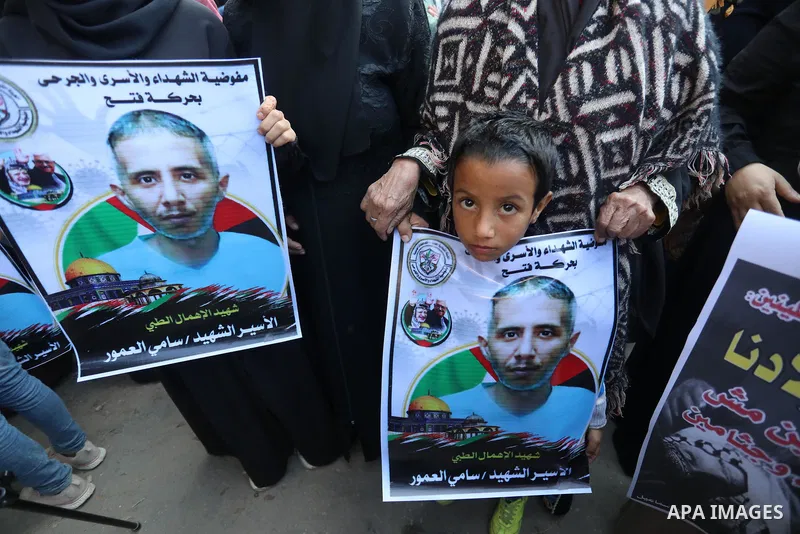 Palestinians take part in a protest against the death of prisoner Sami al-Amour in Israeli Jails as a result of intentional medical negligence, in Red cross office, in Gaza city on November 22, 2021. The al-Amour, 39, fr...
