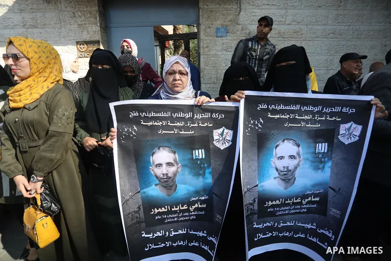 Palestinians take part in a protest against the death of prisoner Sami al-Amour in Israeli Jails as a result of intentional medical negligence, in Red cross office, in Gaza city on November 22, 2021. The al-Amour, 39, fr...
