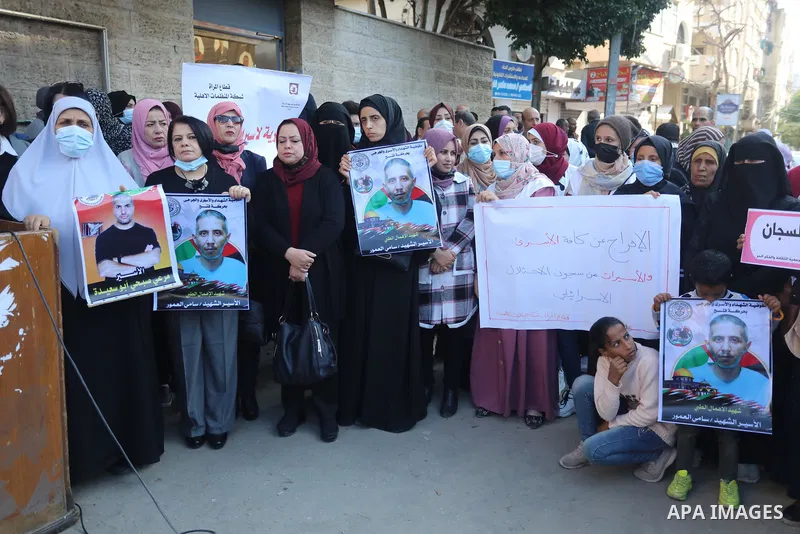 Palestinians take part in a protest against the death of prisoner Sami al-Amour in Israeli Jails as a result of intentional medical negligence, in Red cross office, in Gaza city on November 22, 2021. The al-Amour, 39, fr...