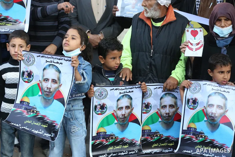 Palestinians take part in a protest against the death of prisoner Sami al-Amour in Israeli Jails as a result of intentional medical negligence, in Red cross office, in Gaza city on November 22, 2021. The al-Amour, 39, fr...