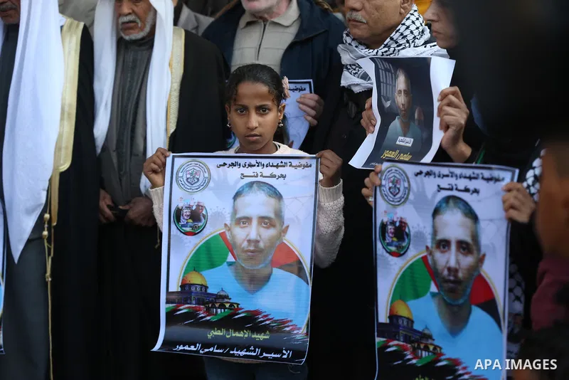Palestinians take part in a protest against the death of prisoner Sami al-Amour in Israeli Jails as a result of intentional medical negligence, in Red cross office, in Gaza city on November 22, 2021. The al-Amour, 39, fr...