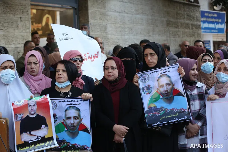Palestinians take part in a protest against the death of prisoner Sami al-Amour in Israeli Jails as a result of intentional medical negligence, in Red cross office, in Gaza city on November 22, 2021. The al-Amour, 39, fr...