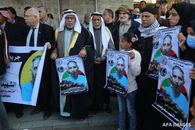 Palestinians take part in a protest against the death of prisoner Sami al-Amour in Israeli Jails as a result of intentional medical negligence, in Red cross office, in Gaza city on November 22, 2021. The al-Amour, 39, fr...