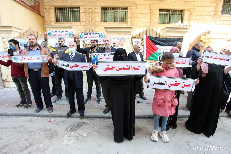 Palestinians hold IDs and banners to demand of the family reunification in front of the headquarter United Nation "UNSCO" in Gaza city, on 22 November 2021. Thousands of Palestinians have suffered as a result of the law,...