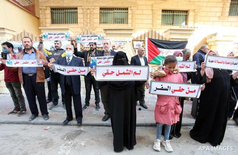 Palestinians hold IDs and banners to demand of the family reunification in front of the headquarter United Nation "UNSCO" in Gaza city, on 22 November 2021. Thousands of Palestinians have suffered as a result of the law,...