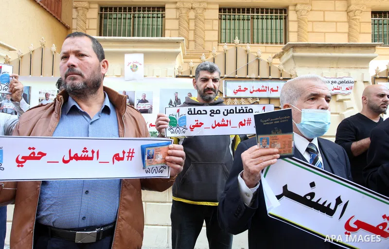 Palestinians hold IDs and banners to demand of the family reunification in front of the headquarter United Nation "UNSCO" in Gaza city, on 22 November 2021. Thousands of Palestinians have suffered as a result of the law,...