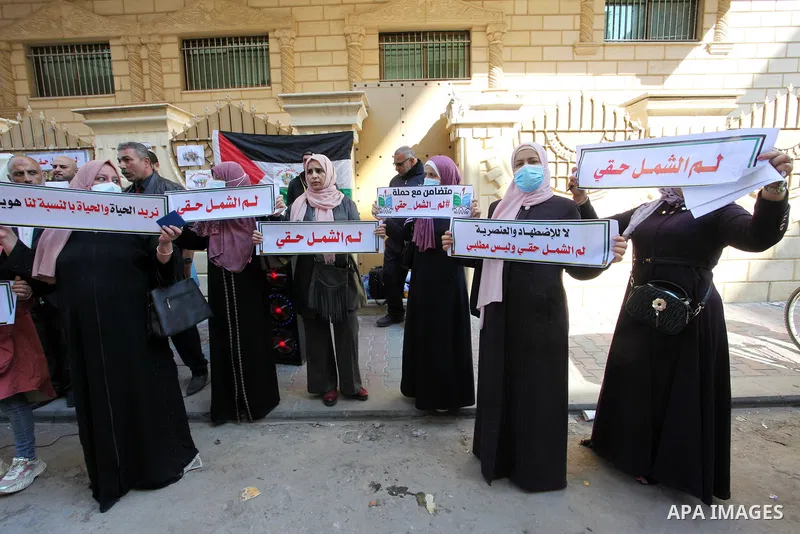 Palestinians hold IDs and banners to demand of the family reunification in front of the headquarter United Nation "UNSCO" in Gaza city, on 22 November 2021. Thousands of Palestinians have suffered as a result of the law,...