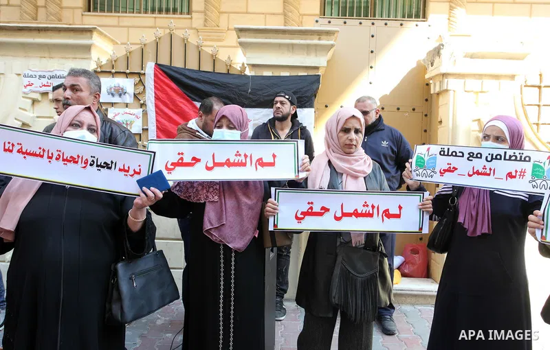 Palestinians hold IDs and banners to demand of the family reunification in front of the headquarter United Nation "UNSCO" in Gaza city, on 22 November 2021. Thousands of Palestinians have suffered as a result of the law,...