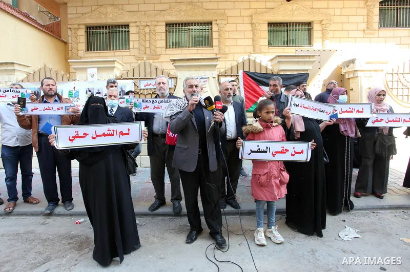 Palestinians hold IDs and banners to demand of the family reunification in front of the headquarter United Nation "UNSCO" in Gaza city, on 22 November 2021. Thousands of Palestinians have suffered as a result of the law,...