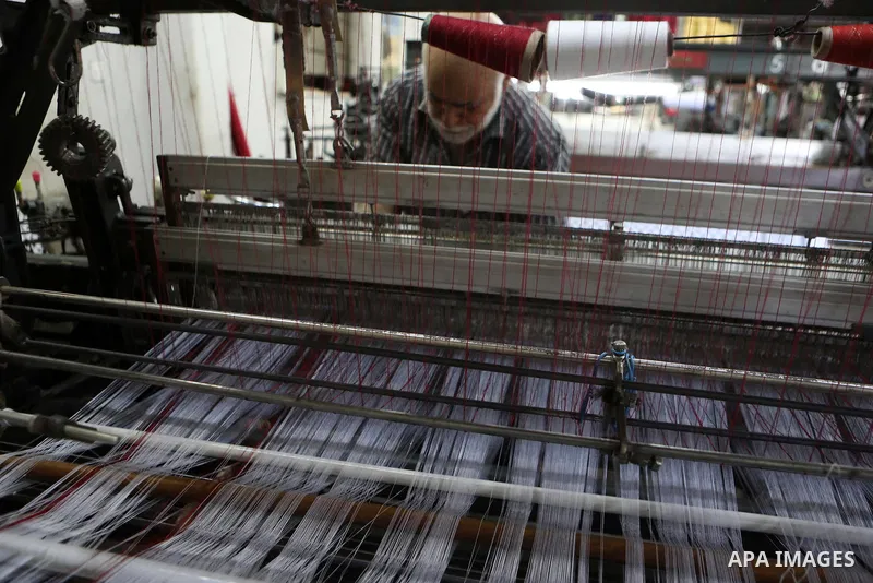 A Palestinian man works at a Keffiyeh textile factory in the West Bank City of Hebron, on November 22, 2021. Keffiyeh is black-and-white chequered scarf is a traditional Arabian headdress. Photo by Mamoun Wazwaz