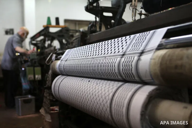 A Palestinian man works at a Keffiyeh textile factory in the West Bank City of Hebron, on November 22, 2021. Keffiyeh is black-and-white chequered scarf is a traditional Arabian headdress. Photo by Mamoun Wazwaz