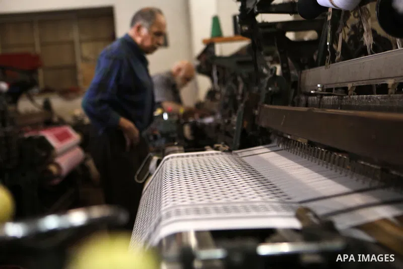 A Palestinian man works at a Keffiyeh textile factory in the West Bank City of Hebron, on November 22, 2021. Keffiyeh is black-and-white chequered scarf is a traditional Arabian headdress. Photo by Mamoun Wazwaz