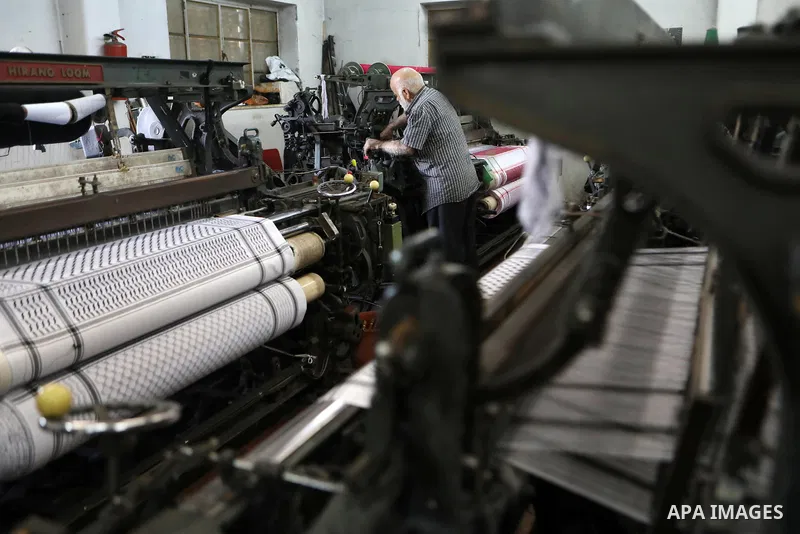 A Palestinian man works at a Keffiyeh textile factory in the West Bank City of Hebron, on November 22, 2021. Keffiyeh is black-and-white chequered scarf is a traditional Arabian headdress. Photo by Mamoun Wazwaz