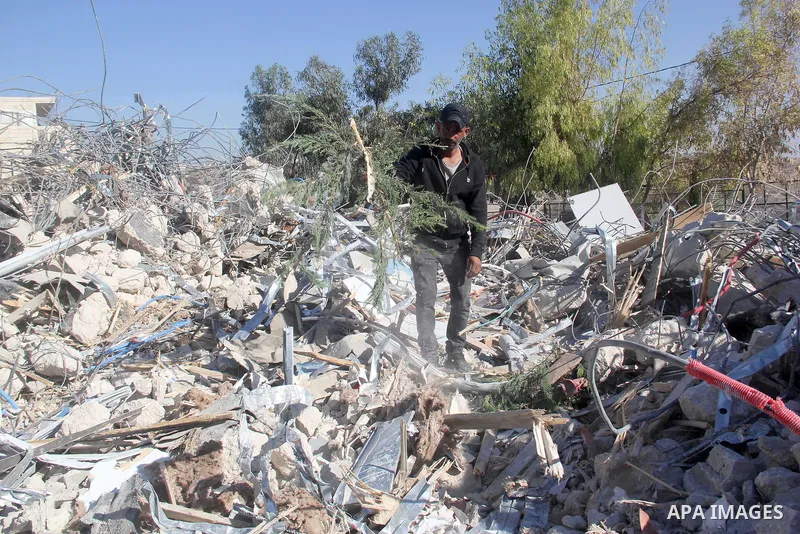 A Palestinian man inspect the debris his house in the village of Sur Baher which sits on either side of the Israeli barrier in East Jerusalem and the Israeli-occupied West Bank November 23, 2021. Photo by Mahfouz Abu Tur...