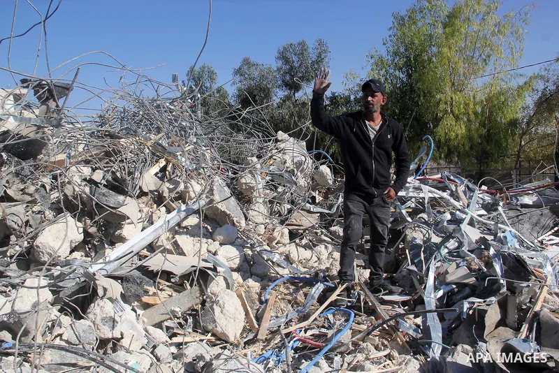A Palestinian man inspect the debris his house in the village of Sur Baher which sits on either side of the Israeli barrier in East Jerusalem and the Israeli-occupied West Bank November 23, 2021. Photo by Mahfouz Abu Tur...