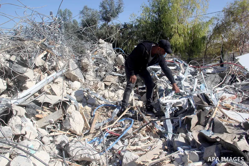 A Palestinian man inspect the debris his house in the village of Sur Baher which sits on either side of the Israeli barrier in East Jerusalem and the Israeli-occupied West Bank November 23, 2021. Photo by Mahfouz Abu Tur...