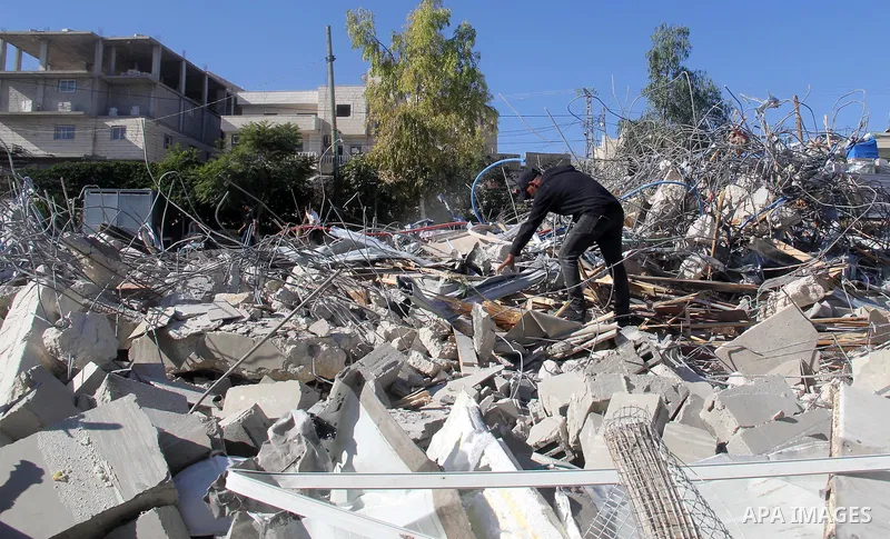 A Palestinian man inspect the debris his house in the village of Sur Baher which sits on either side of the Israeli barrier in East Jerusalem and the Israeli-occupied West Bank November 23, 2021. Photo by Mahfouz Abu Tur...
