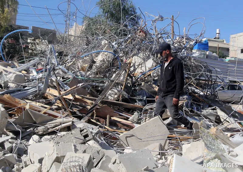 A Palestinian man inspect the debris his house in the village of Sur Baher which sits on either side of the Israeli barrier in East Jerusalem and the Israeli-occupied West Bank November 23, 2021. Photo by Mahfouz Abu Tur...