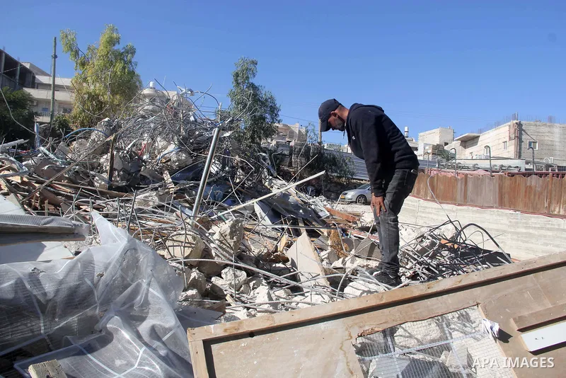 A Palestinian man inspect the debris his house in the village of Sur Baher which sits on either side of the Israeli barrier in East Jerusalem and the Israeli-occupied West Bank November 23, 2021. Photo by Mahfouz Abu Tur...