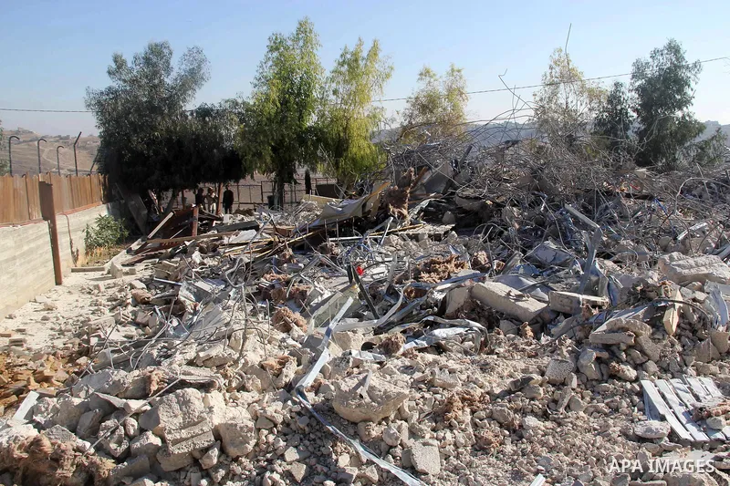 A Palestinian man inspect the debris his house in the village of Sur Baher which sits on either side of the Israeli barrier in East Jerusalem and the Israeli-occupied West Bank November 23, 2021. Photo by Mahfouz Abu Tur...