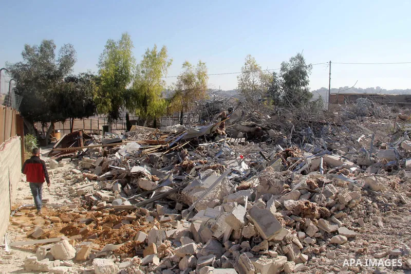 A Palestinian man inspect the debris his house in the village of Sur Baher which sits on either side of the Israeli barrier in East Jerusalem and the Israeli-occupied West Bank November 23, 2021. Photo by Mahfouz Abu Tur...