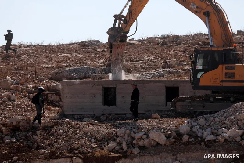 An Israeli bulldozer demolished a Palestinian house located under the pretext of building without a permit in Yatta south of Hebron in the occupied West Bank, on November 23, 2021. According to a report by the Israeli hu...