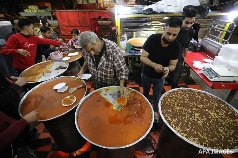 Masoud Al-Qatati, a Palestinian man sells sweets low prices and sometimes free for customers due to the difficult economic conditions of the residents of the Gaza Strip, in Gaza city on November 23, 2021. Al-Qatati said...
