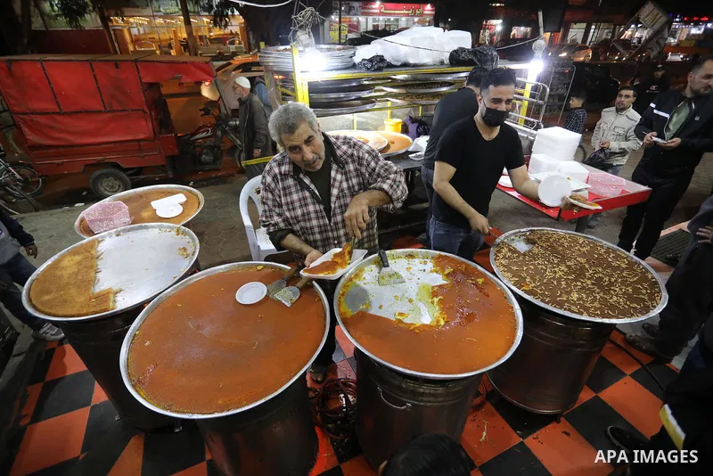 Masoud Al-Qatati, a Palestinian man sells sweets low prices and sometimes free for customers due to the difficult economic conditions of the residents of the Gaza Strip, in Gaza city on November 23, 2021. Al-Qatati said...