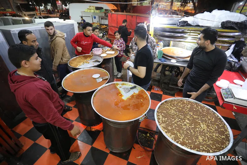 Masoud Al-Qatati, a Palestinian man sells sweets low prices and sometimes free for customers due to the difficult economic conditions of the residents of the Gaza Strip, in Gaza city on November 23, 2021. Al-Qatati said...