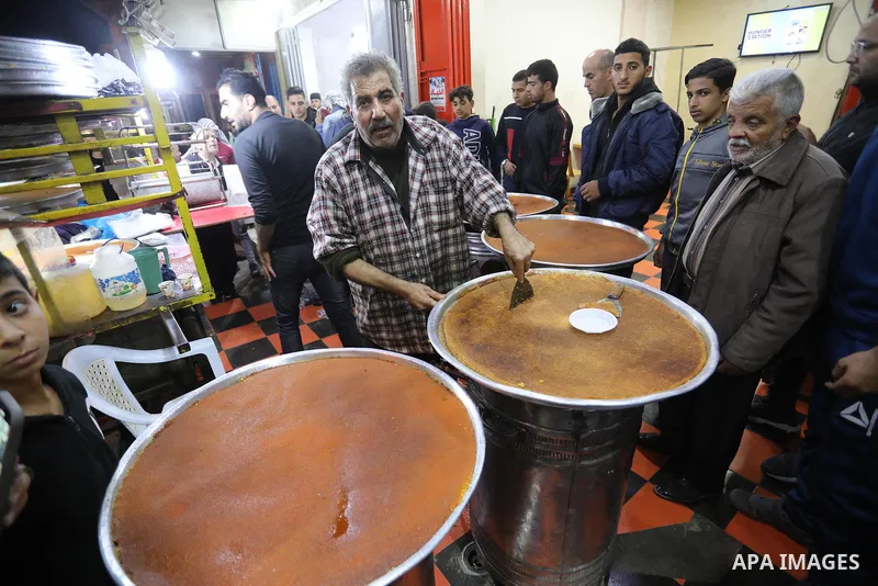 Masoud Al-Qatati, a Palestinian man sells sweets low prices and sometimes free for customers due to the difficult economic conditions of the residents of the Gaza Strip, in Gaza city on November 23, 2021. Al-Qatati said...
