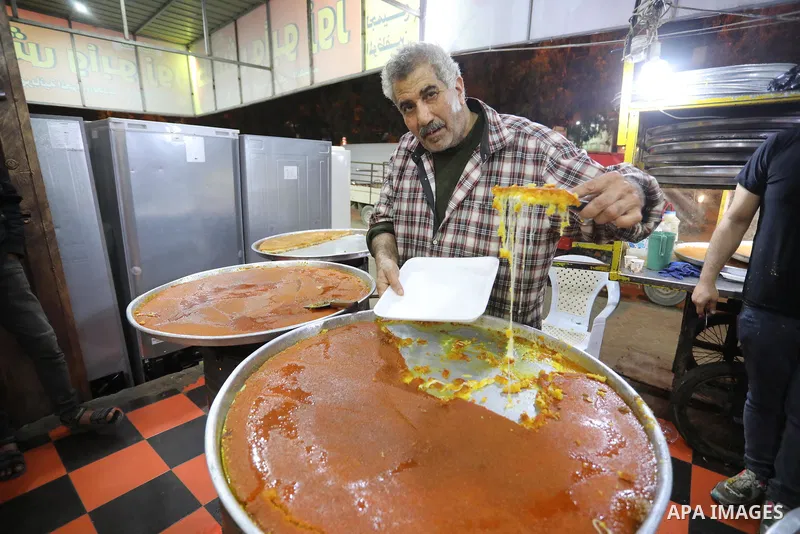 Masoud Al-Qatati, a Palestinian man sells sweets low prices and sometimes free for customers due to the difficult economic conditions of the residents of the Gaza Strip, in Gaza city on November 23, 2021. Al-Qatati said...