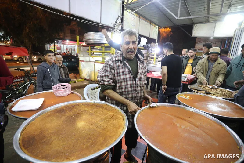 Masoud Al-Qatati, a Palestinian man sells sweets low prices and sometimes free for customers due to the difficult economic conditions of the residents of the Gaza Strip, in Gaza city on November 23, 2021. Al-Qatati said...
