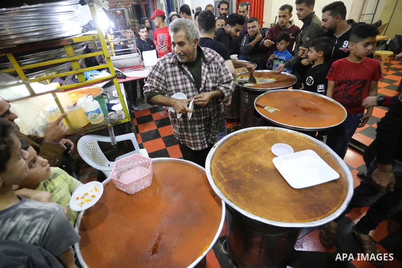 Masoud Al-Qatati, a Palestinian man sells sweets low prices and sometimes free for customers due to the difficult economic conditions of the residents of the Gaza Strip, in Gaza city on November 23, 2021. Al-Qatati said...