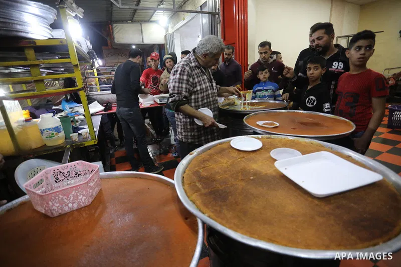 Masoud Al-Qatati, a Palestinian man sells sweets low prices and sometimes free for customers due to the difficult economic conditions of the residents of the Gaza Strip, in Gaza city on November 23, 2021. Al-Qatati said...