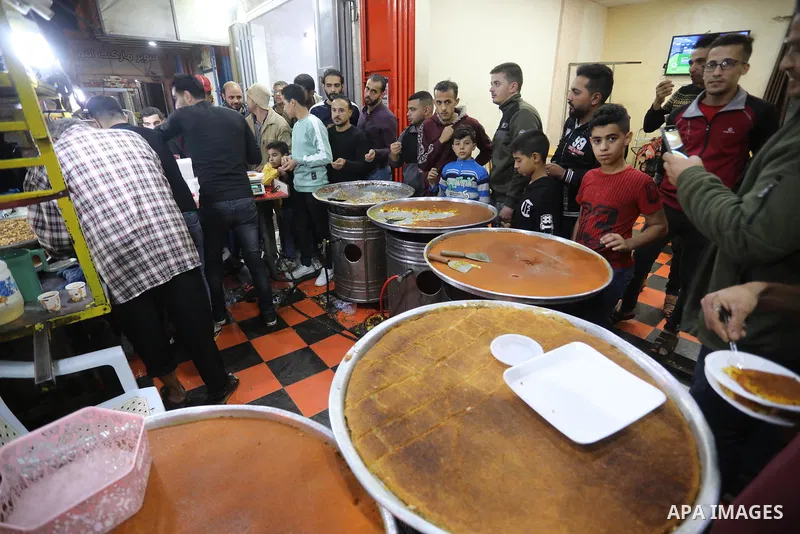 Masoud Al-Qatati, a Palestinian man sells sweets low prices and sometimes free for customers due to the difficult economic conditions of the residents of the Gaza Strip, in Gaza city on November 23, 2021. Al-Qatati said...