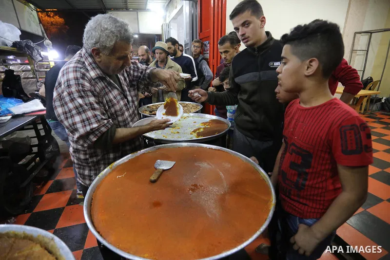 Masoud Al-Qatati, a Palestinian man sells sweets low prices and sometimes free for customers due to the difficult economic conditions of the residents of the Gaza Strip, in Gaza city on November 23, 2021. Al-Qatati said...