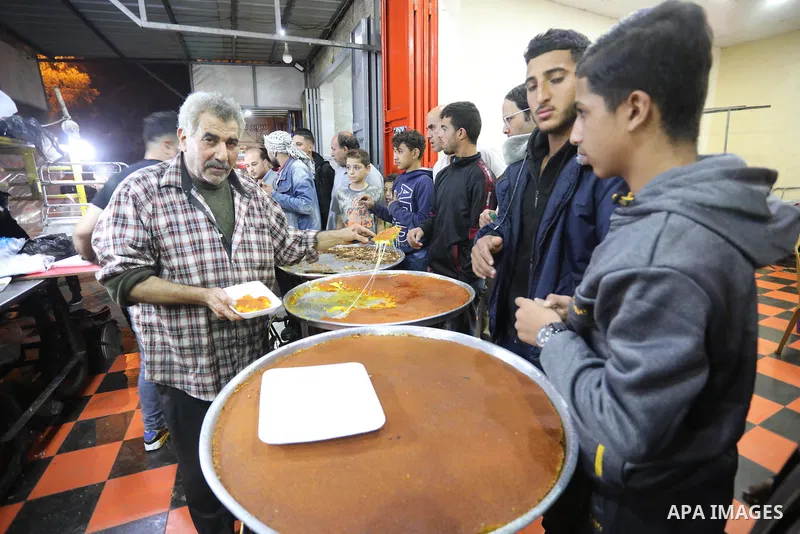 Masoud Al-Qatati, a Palestinian man sells sweets low prices and sometimes free for customers due to the difficult economic conditions of the residents of the Gaza Strip, in Gaza city on November 23, 2021. Al-Qatati said...