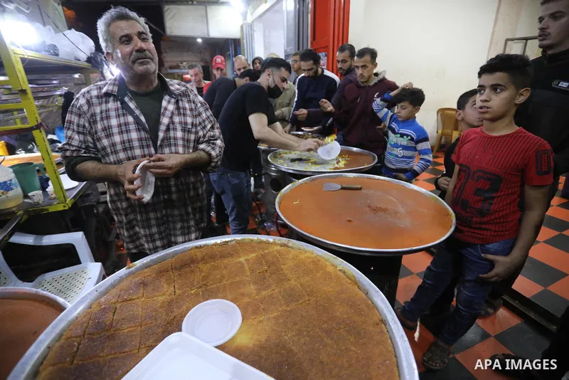 Masoud Al-Qatati, a Palestinian man sells sweets low prices and sometimes free for customers due to the difficult economic conditions of the residents of the Gaza Strip, in Gaza city on November 23, 2021. Al-Qatati said...