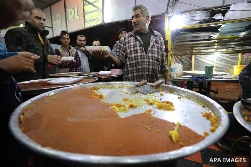 Masoud Al-Qatati, a Palestinian man sells sweets low prices and sometimes free for customers due to the difficult economic conditions of the residents of the Gaza Strip, in Gaza city on November 23, 2021. Al-Qatati said...