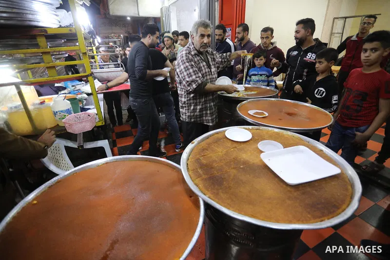 Masoud Al-Qatati, a Palestinian man sells sweets low prices and sometimes free for customers due to the difficult economic conditions of the residents of the Gaza Strip, in Gaza city on November 23, 2021. Al-Qatati said...