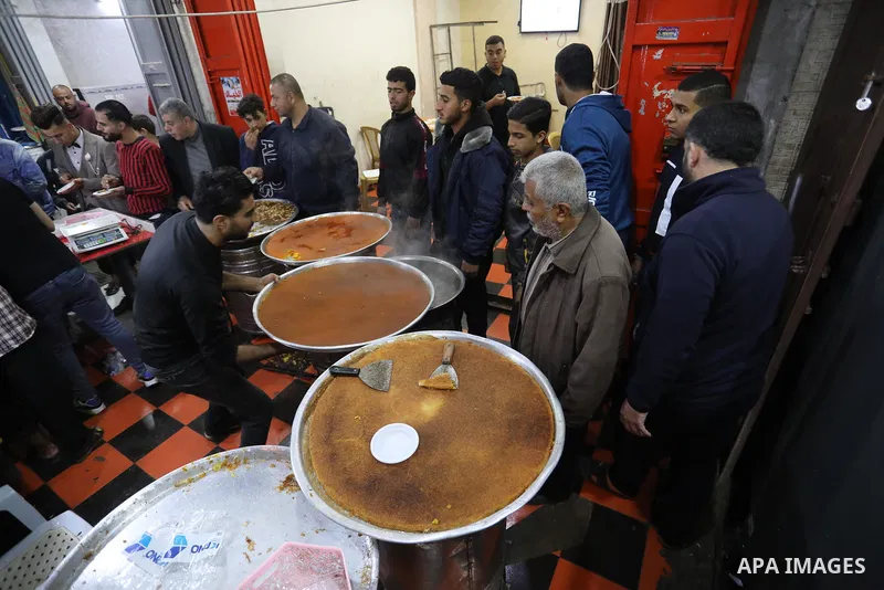 Masoud Al-Qatati, a Palestinian man sells sweets low prices and sometimes free for customers due to the difficult economic conditions of the residents of the Gaza Strip, in Gaza city on November 23, 2021. Al-Qatati said...