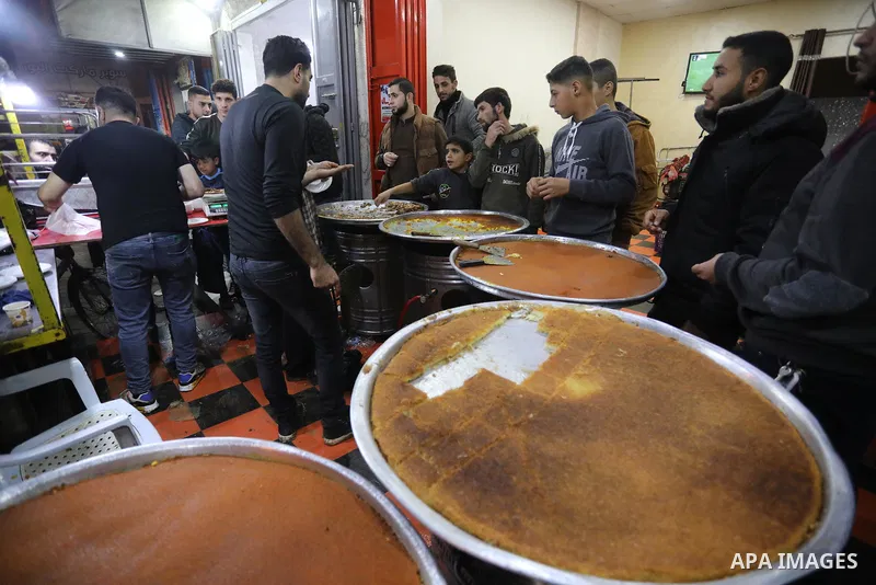 Masoud Al-Qatati, a Palestinian man sells sweets low prices and sometimes free for customers due to the difficult economic conditions of the residents of the Gaza Strip, in Gaza city on November 23, 2021. Al-Qatati said...
