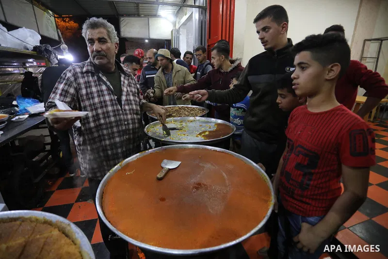 Masoud Al-Qatati, a Palestinian man sells sweets low prices and sometimes free for customers due to the difficult economic conditions of the residents of the Gaza Strip, in Gaza city on November 23, 2021. Al-Qatati said...