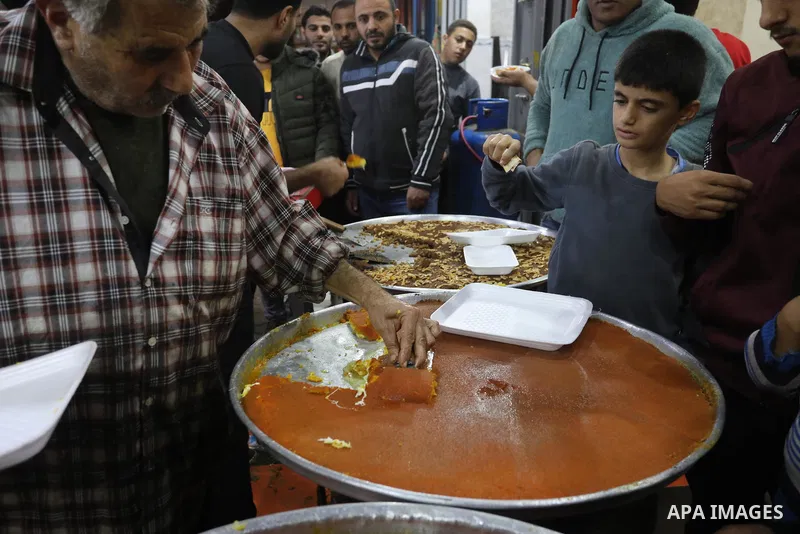 Masoud Al-Qatati, a Palestinian man sells sweets low prices and sometimes free for customers due to the difficult economic conditions of the residents of the Gaza Strip, in Gaza city on November 23, 2021. Al-Qatati said...